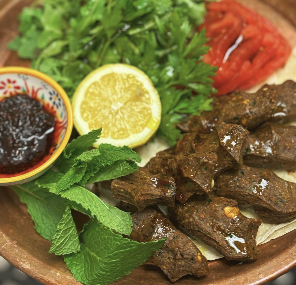 Traditional Turkish çiğ köfte served with fresh greens and lemon slices at a Mediterranean restaurant Miami.