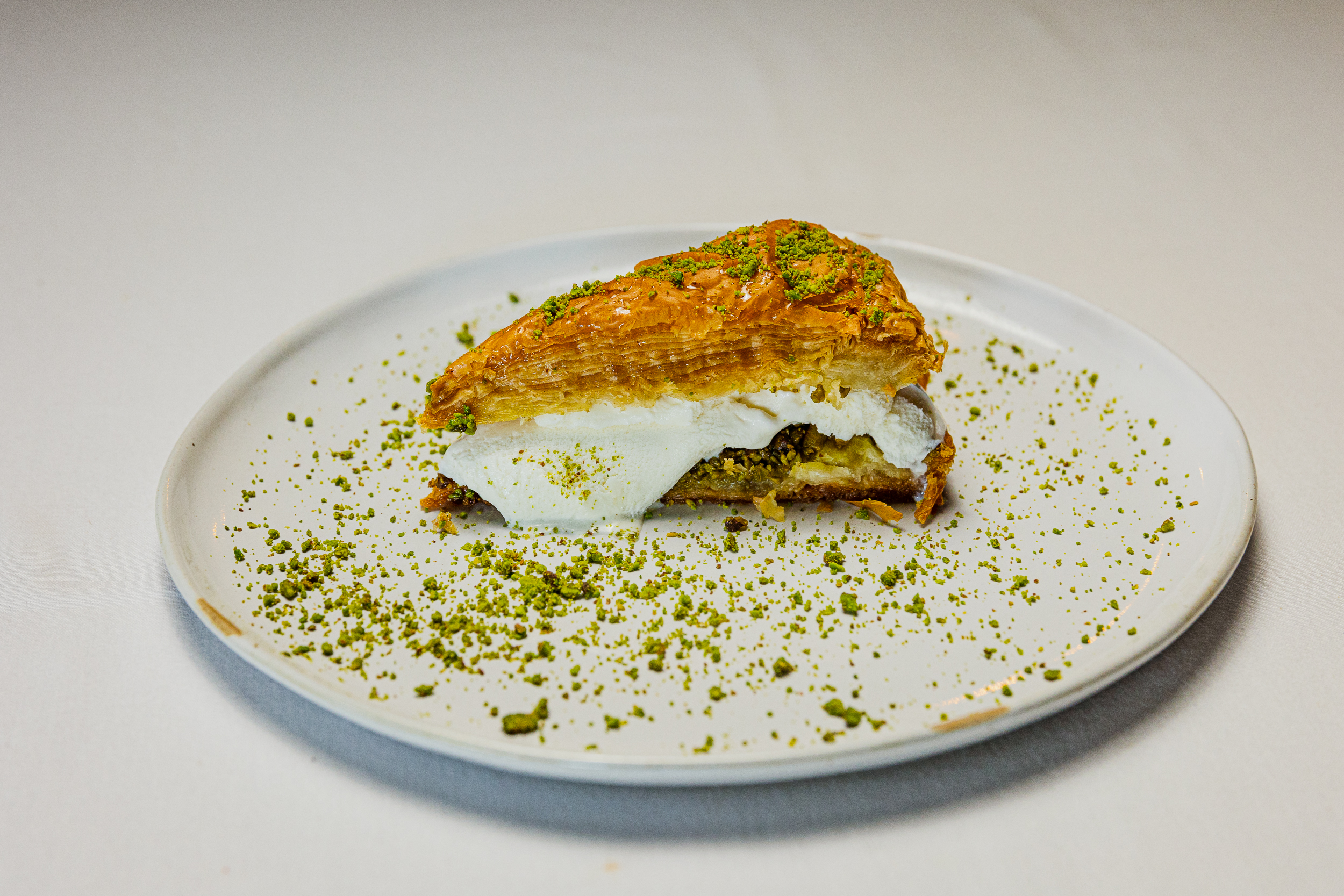 A close-up of the best Turkish baklava in Miami served at Jass Kitchen on a white plate