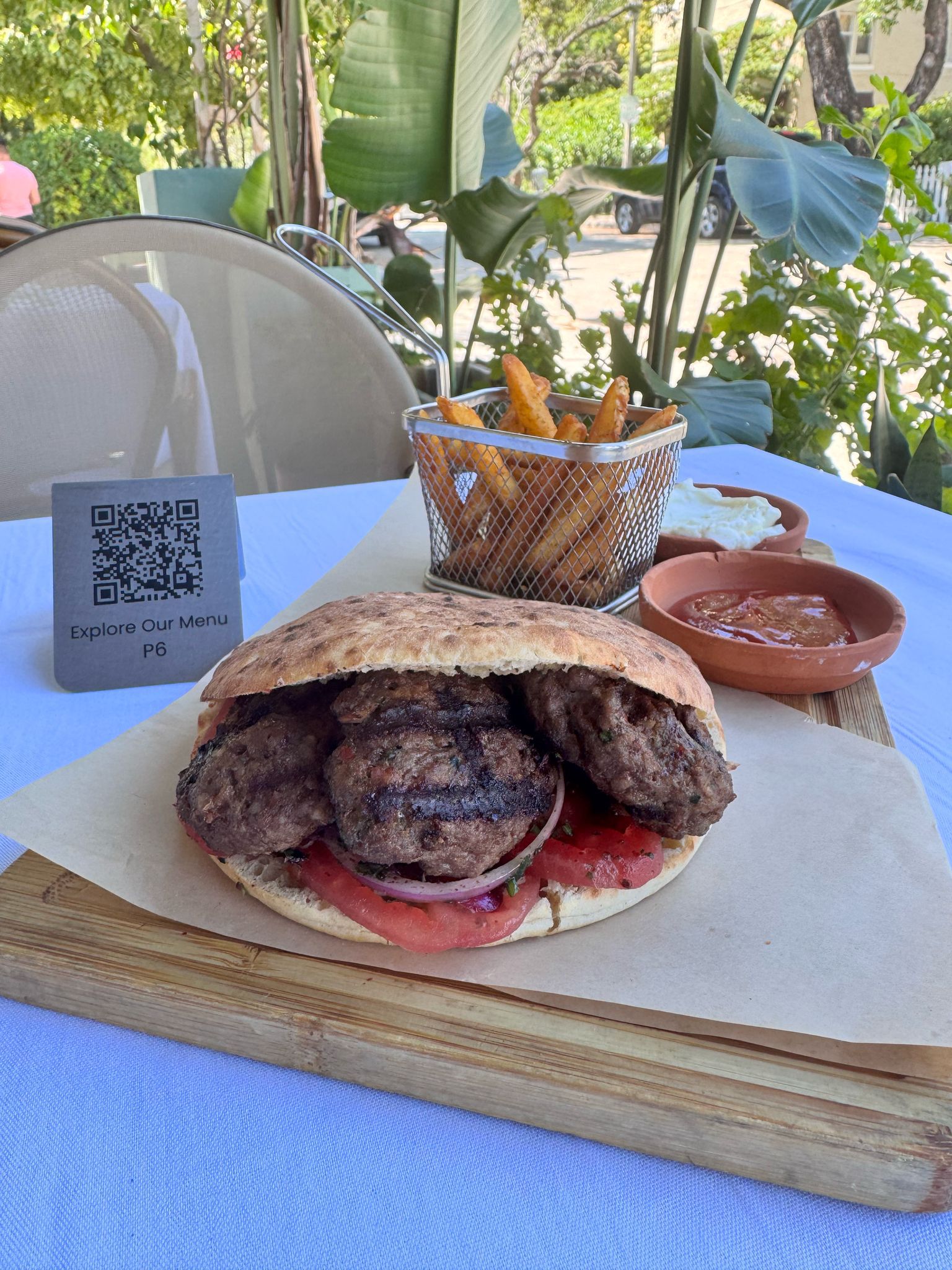 Kofte sandwich served with French fries and dips at Jass Kitchen, the best lunch restaurant in Miami offering authentic Mediterranean flavors.