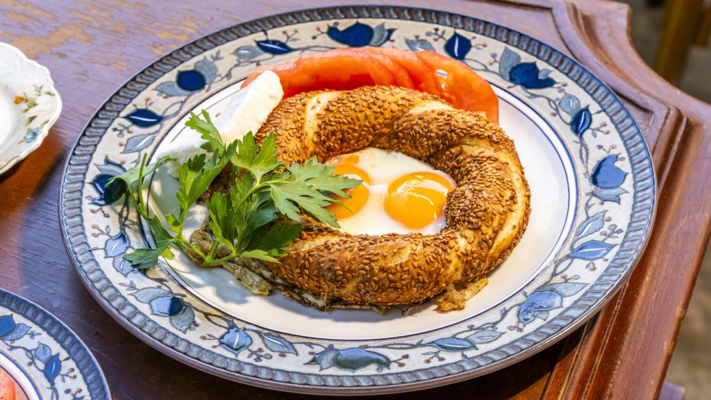 Turkish simit with eggs served on a decorative plate at one of the best brunch in Miami locations, offering an authentic Mediterranean brunch experience.