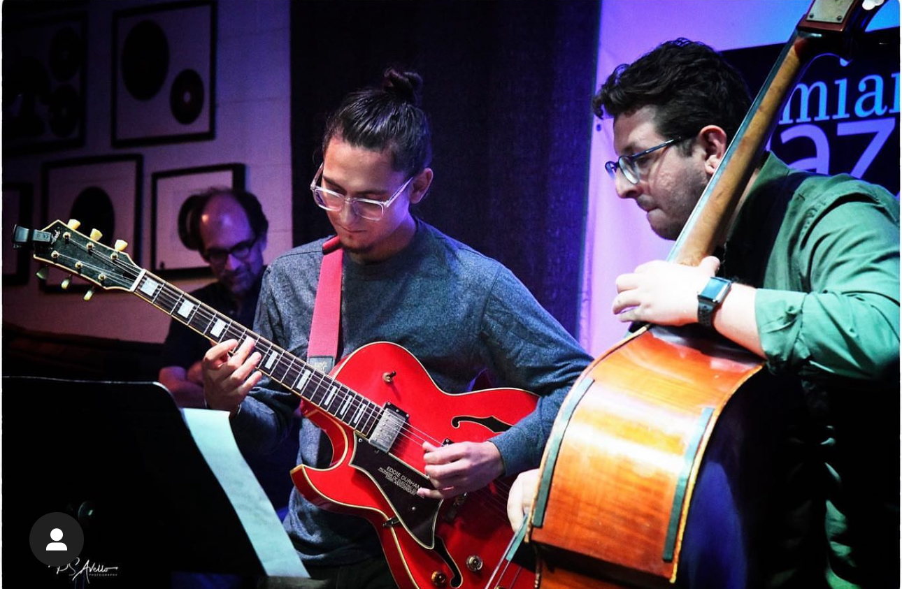 Elegant party setting with guests enjoying music, food, and drinks in a vibrant Miami atmosphere