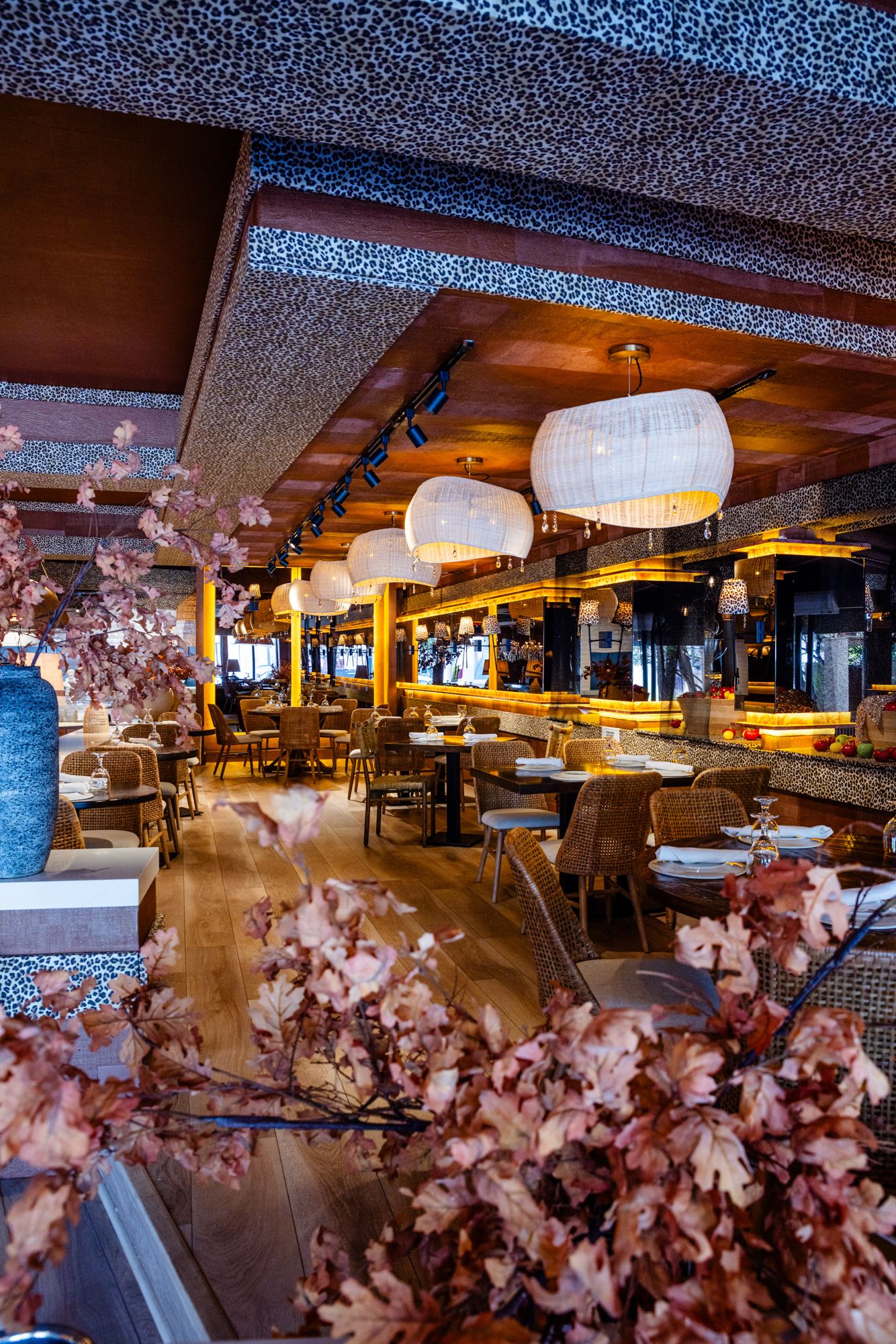 Interior of Babylon Miami Beach, a top-rated Mediterranean restaurant in Miami, featuring warm lighting, floral decor, and elegant dining atmosphere.