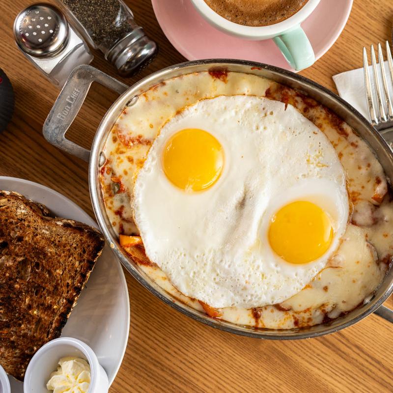 Shakshuka with baked eggs in marinara sauce served with toast at 5800 North Cafe