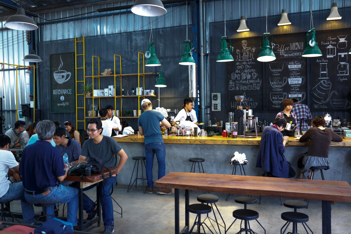 Baristas serving guests at a busy counter