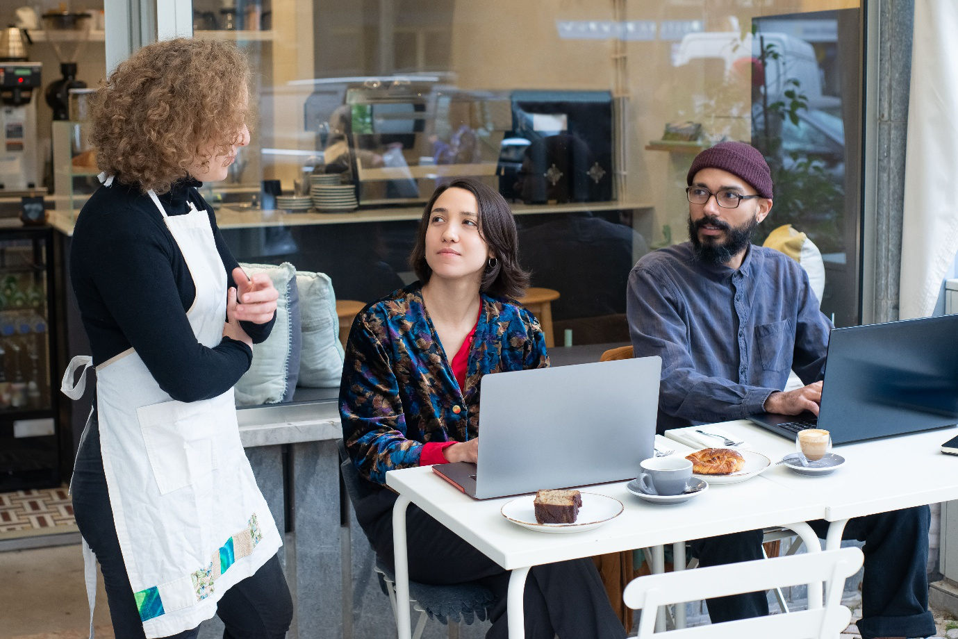 A waitress talking to customers