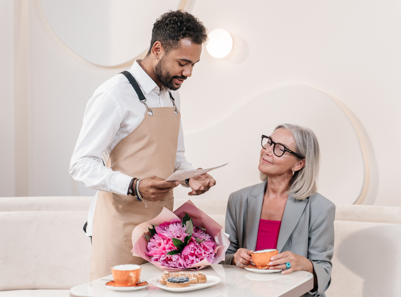 A waiter talking to a customer