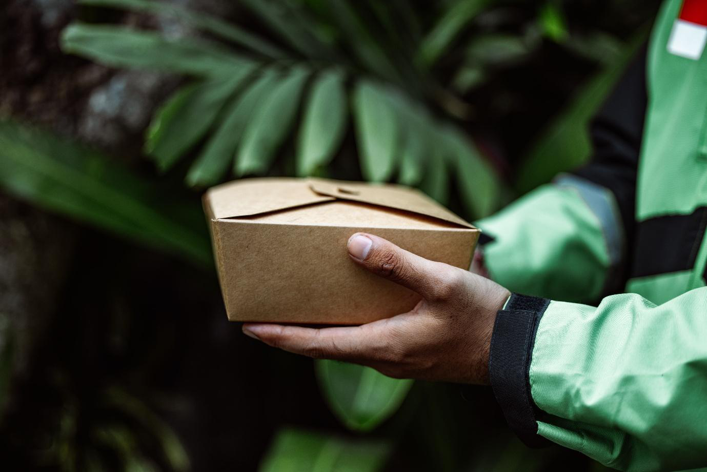 A person holding a delivery box