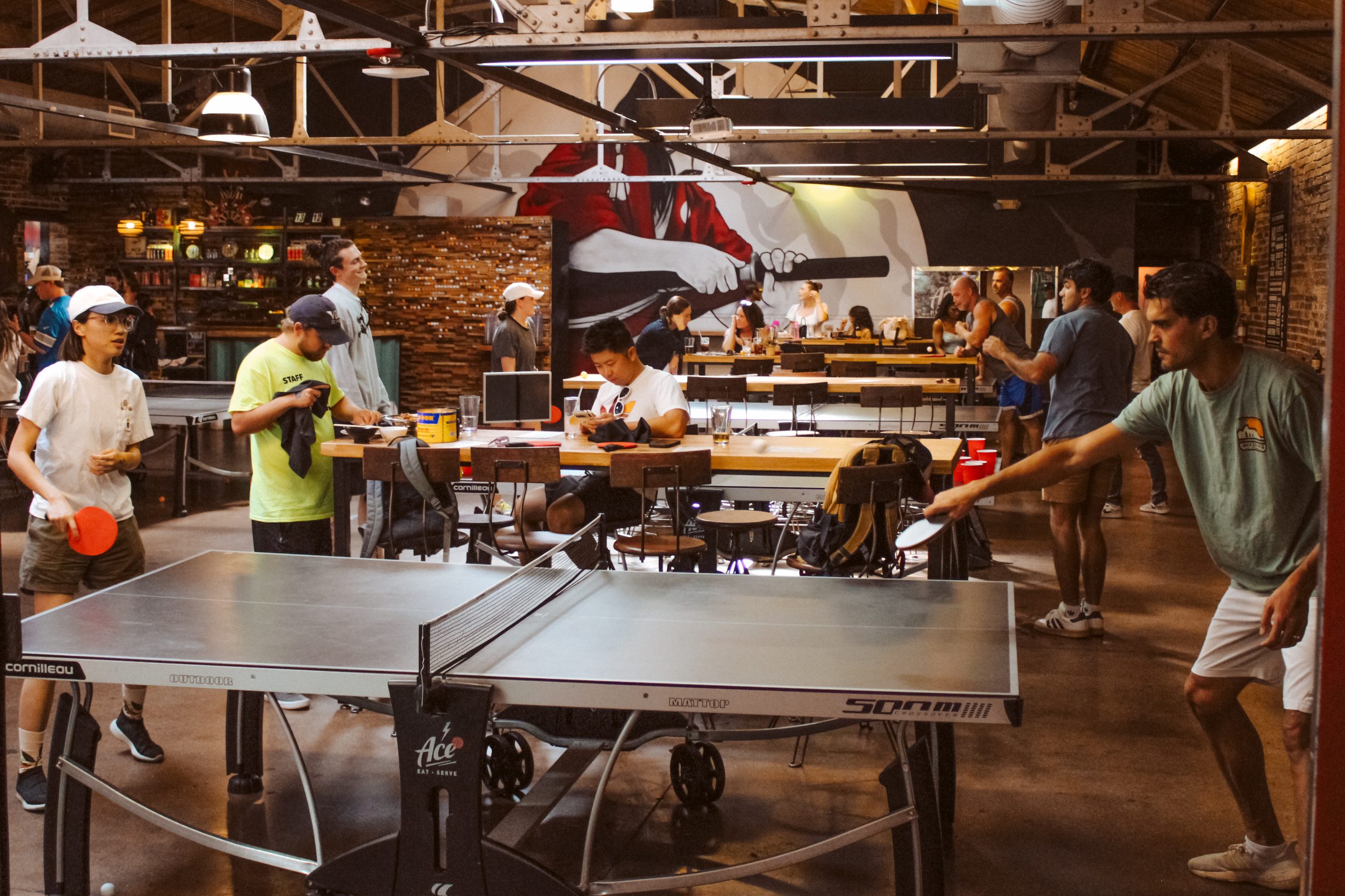 people playing on ping pong tables