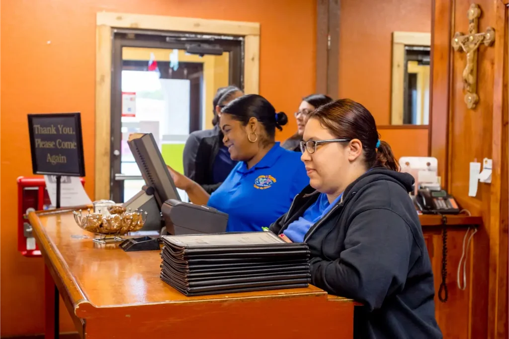 Restaurant staff at the checkout.