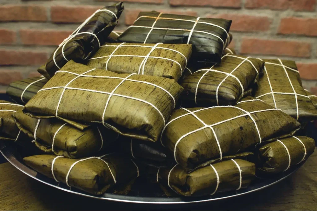 Wrapped tamales on a plate