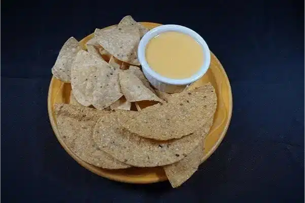 Tortilla chips with cheese dip.