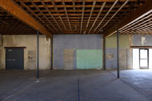 An empty room with wooden beams.